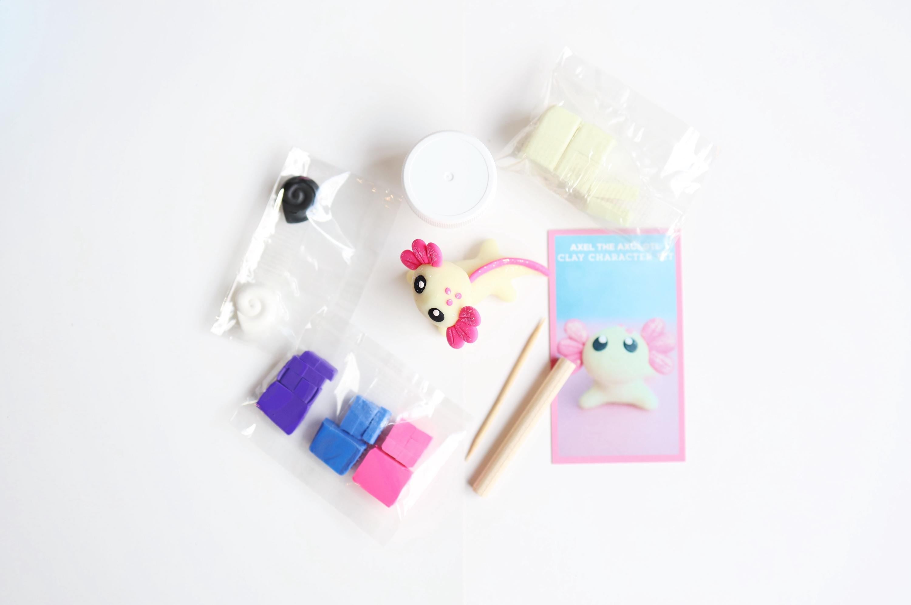 Set of colorful polymer clay for axolotl character on a white background