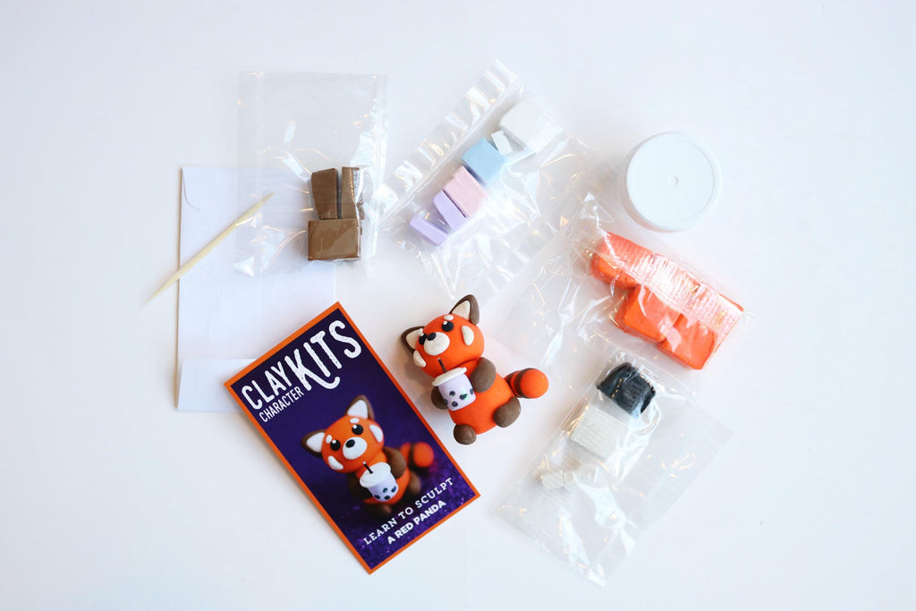 Clay kit with red panda shaped clay figure and packaging on a white background
