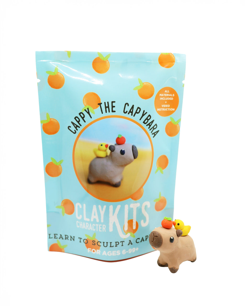 Capybara clay kit with packaging featuring a capybara and orange elements on a white background