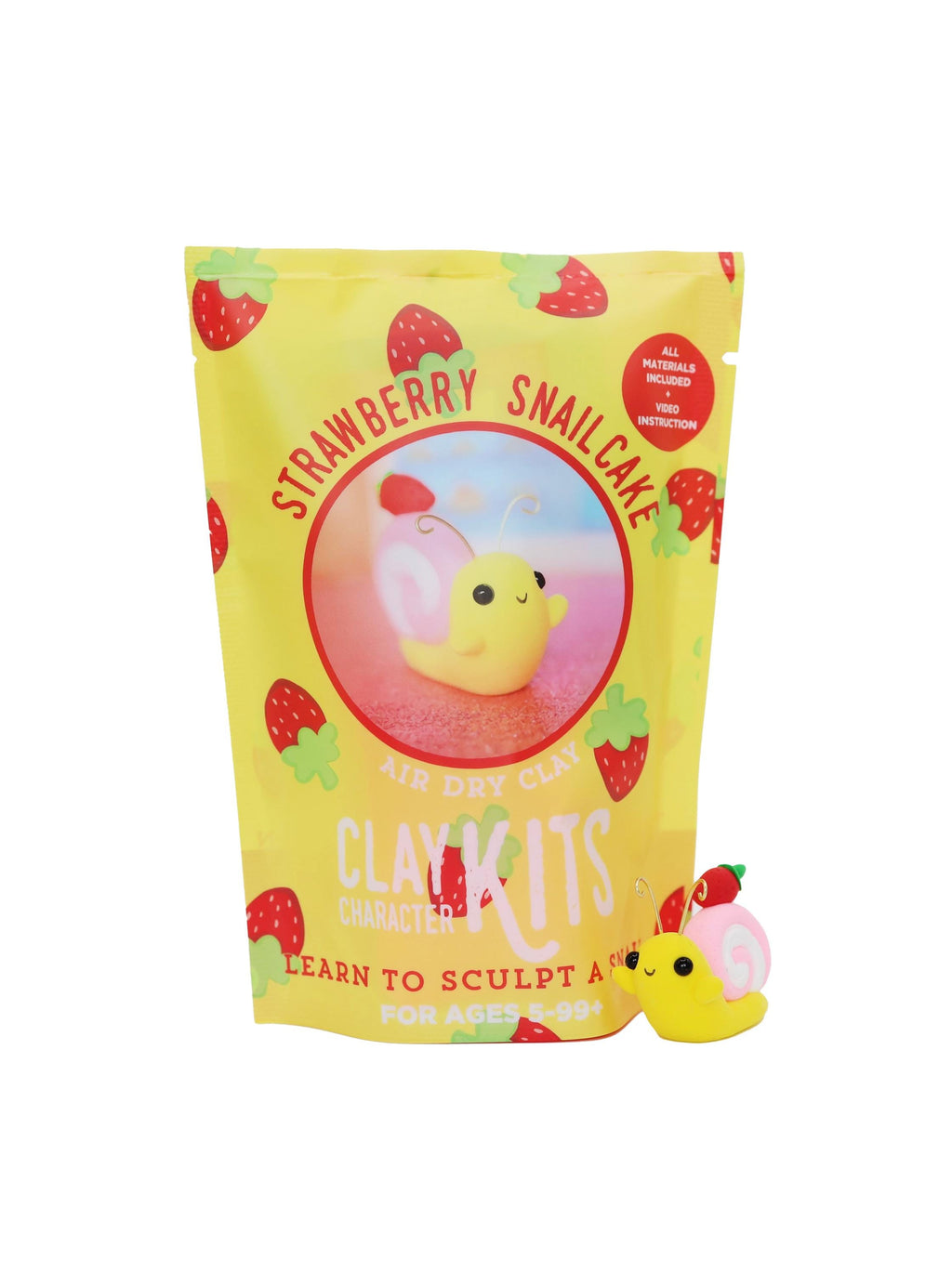 Yellow packaging of Strawberry Snail Cake with a small yellow snail cake toy on a white background