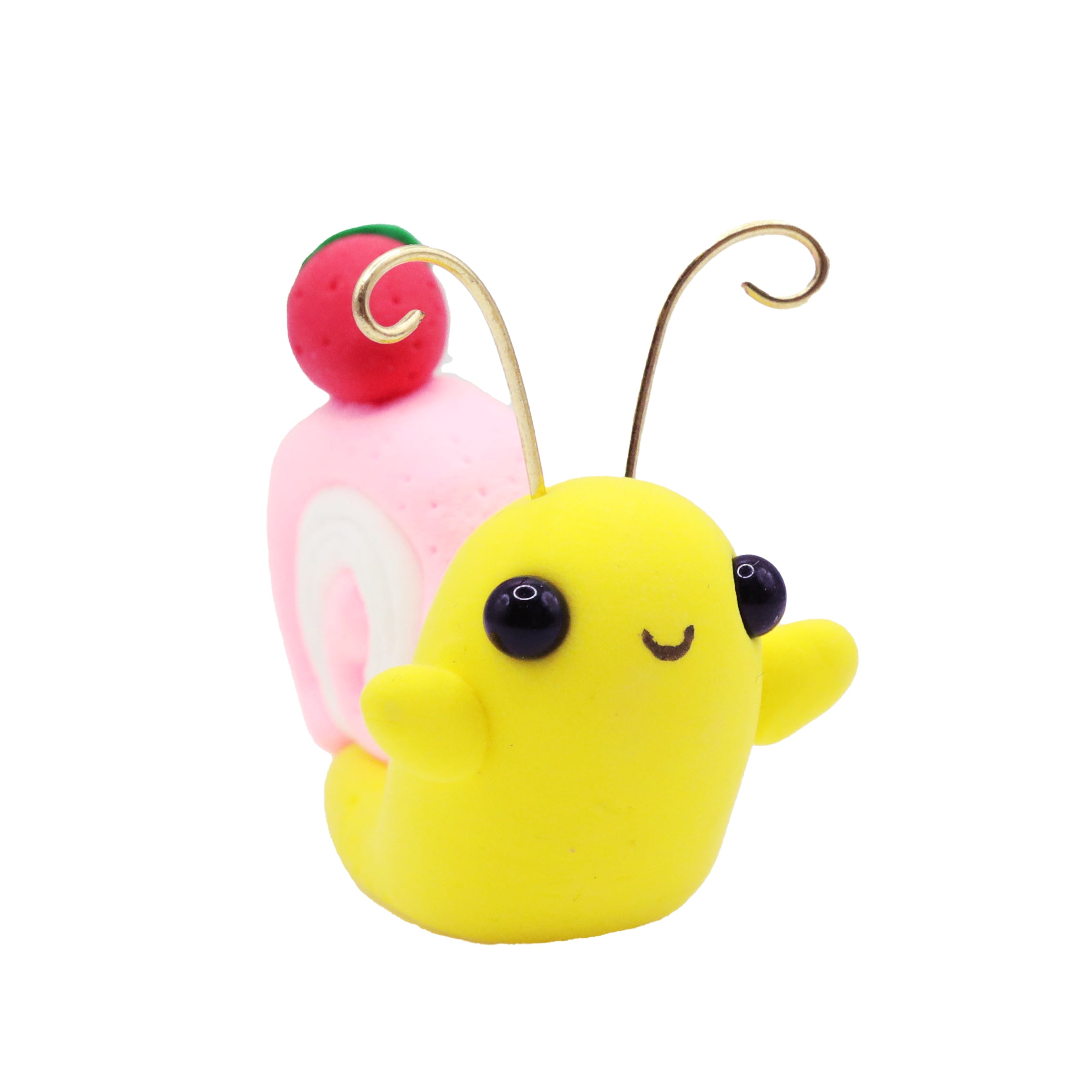 Yellow air dry foam clay snail with a pink and red cake on a white background